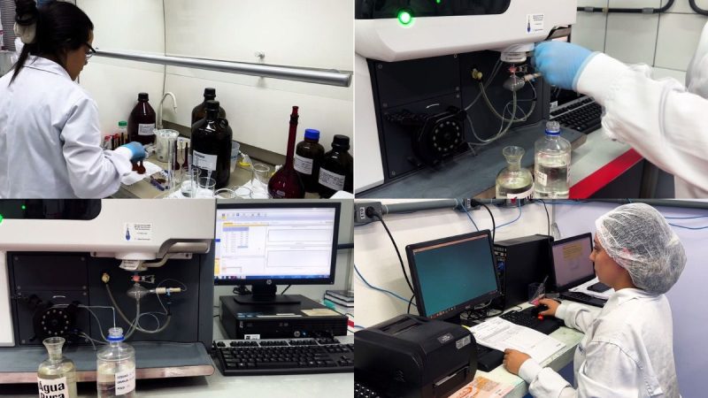 Pesquisadores analisando amostras de água em laboratório com instrumentos e computadores, destacando a qualidade da água na produção animal no agro.