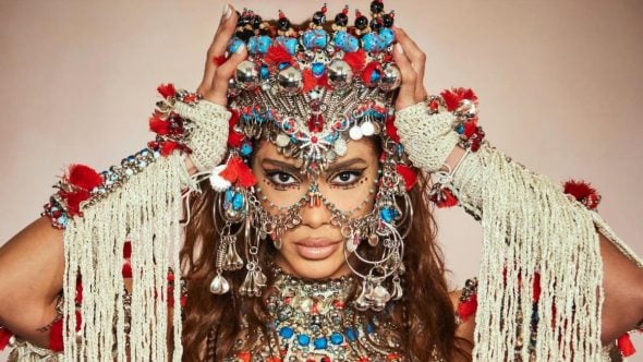 ensaios da anitta 2027: Anitta em ensaio com figurino carnavalesco elaborado, adornos e brilhos, em foto de alta produção para divulgação dos ensaios da artista em Jaguariúna.